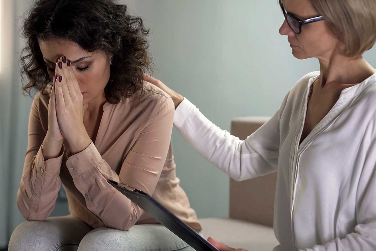 woman with therapist learning what is trauma informed care